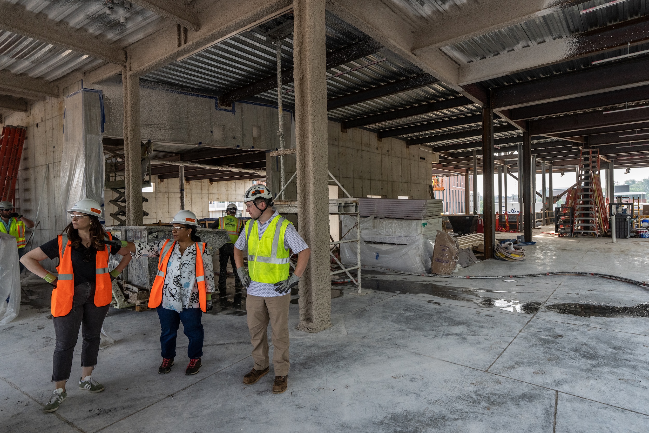people in construction gear inside building