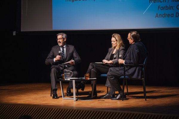 Panelists speaking on a stage