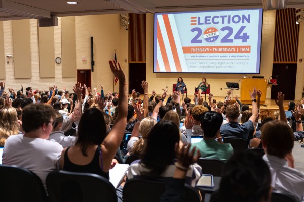 Raising hands in a lecture about election 2024