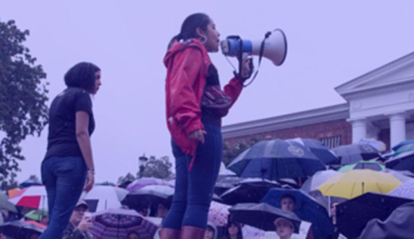Young woman with megaphone over crowd