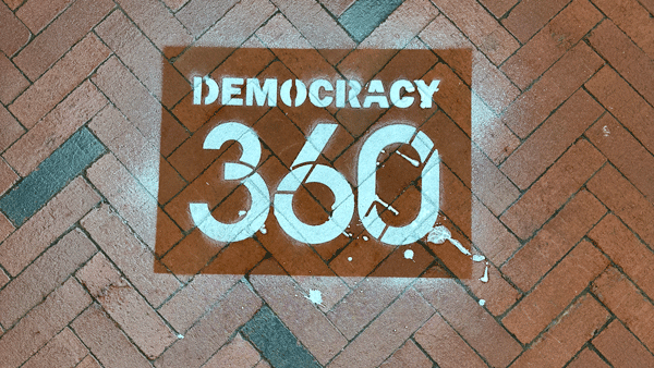 Democracy360 logo on a brick walkway