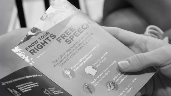 Student holding a pamphlet about free speech
