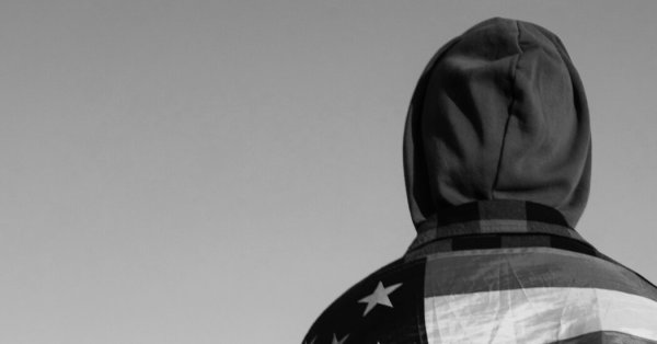 Black and white photo of someone wearing an American flag robe