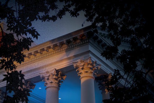 UVA pilars lit up at night