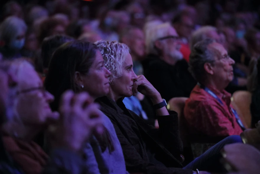 A close up of the crowd at Democracy360 intently listening