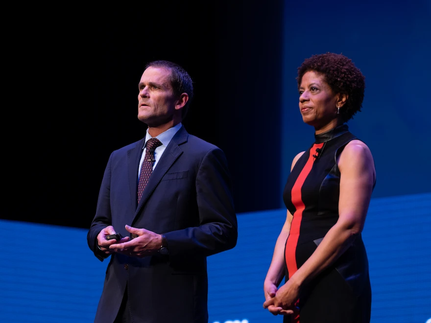 Jim Ryan and Melody Barnes standing on stage at Democracy360